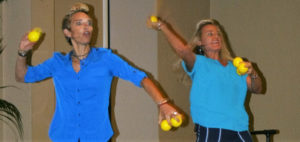 Image of Happy Map presenters throwing happy stress balls into audience to catch