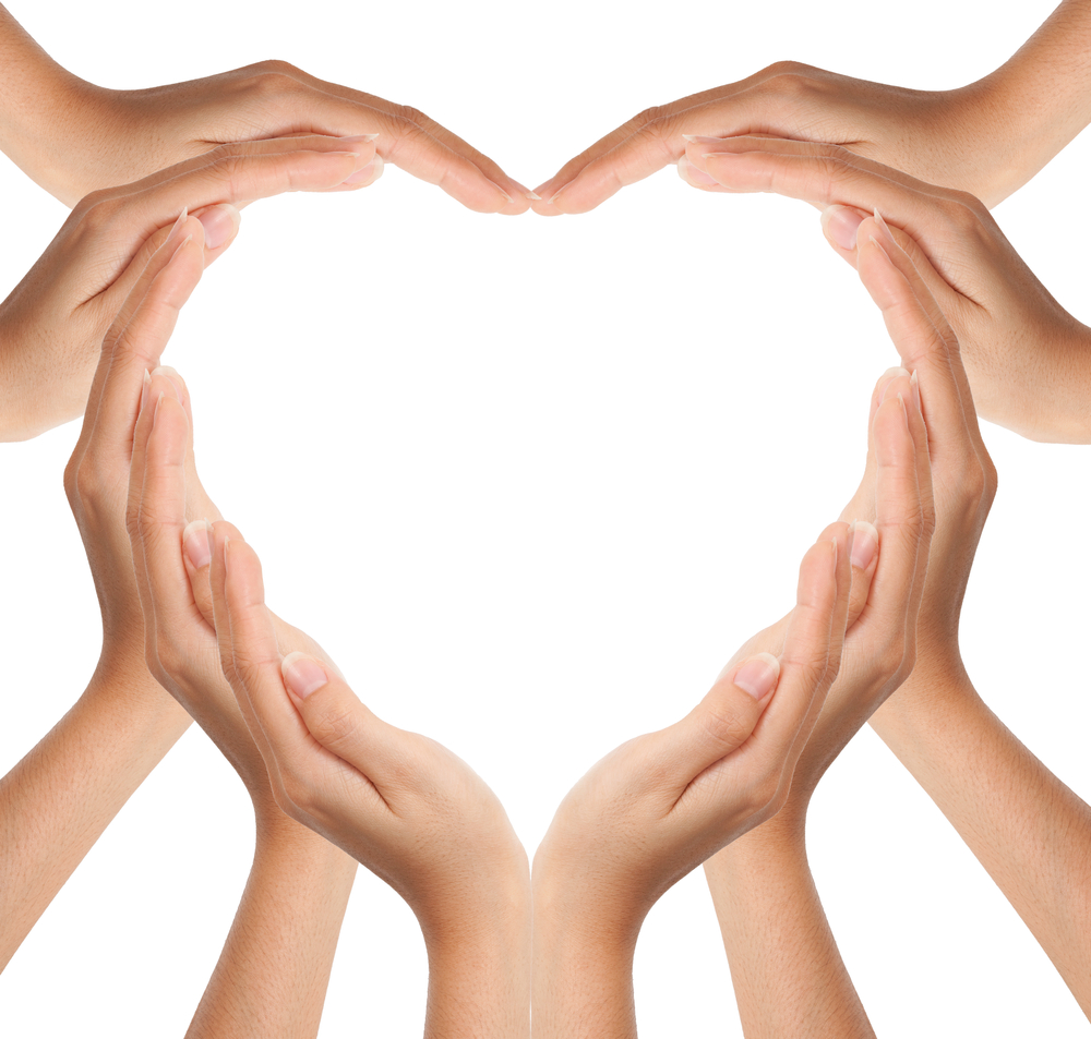 Hands forming a heart shape on a white background.