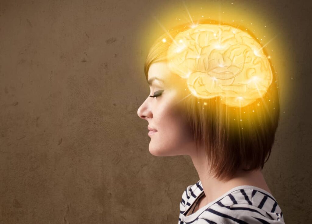 A woman in profile with an illustrated glowing brain superimposed over her head, symbolizing creativity or intelligence.