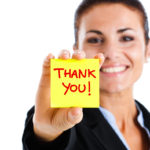 image of a woman holding a thank you post it note